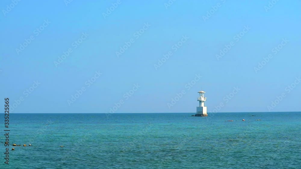 white lighthouse is surrounded by coral reefs in the sea and blue sky white lighthouse is surrounded by coral reefs in the sea and blue sky