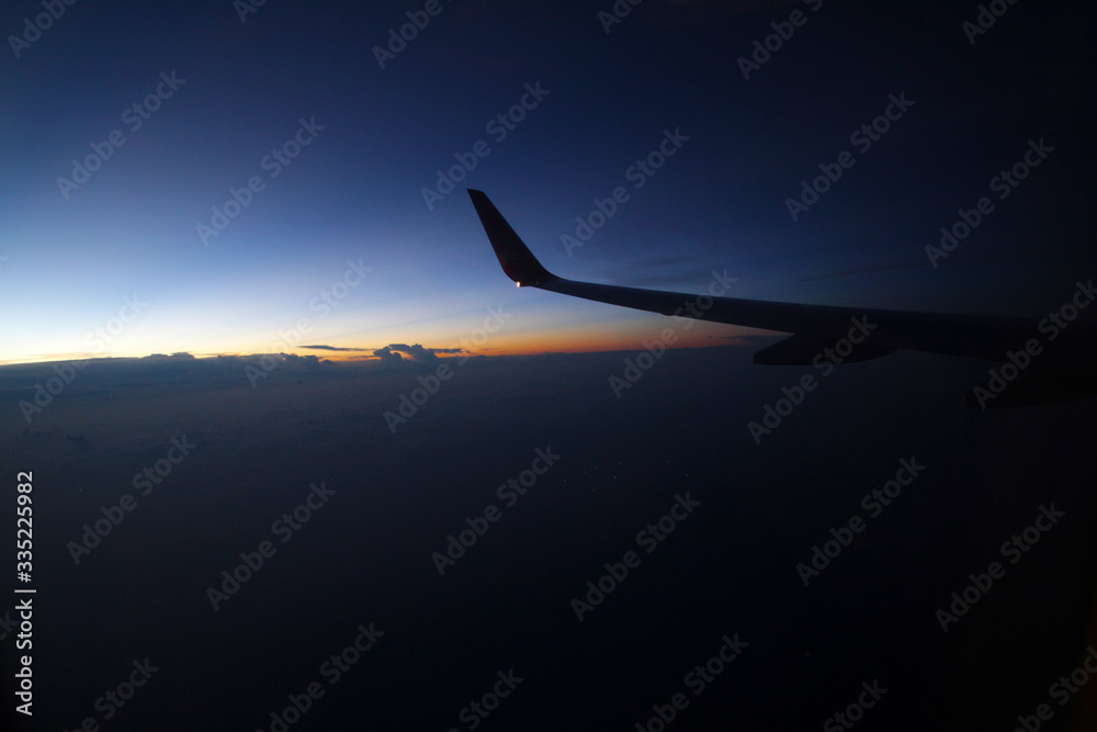 Looking at the beautiful sunset light and shadow colors out of the airplane window at sunset Looking at the beautiful sunset light and shadow colors out of the airplane window at sunset