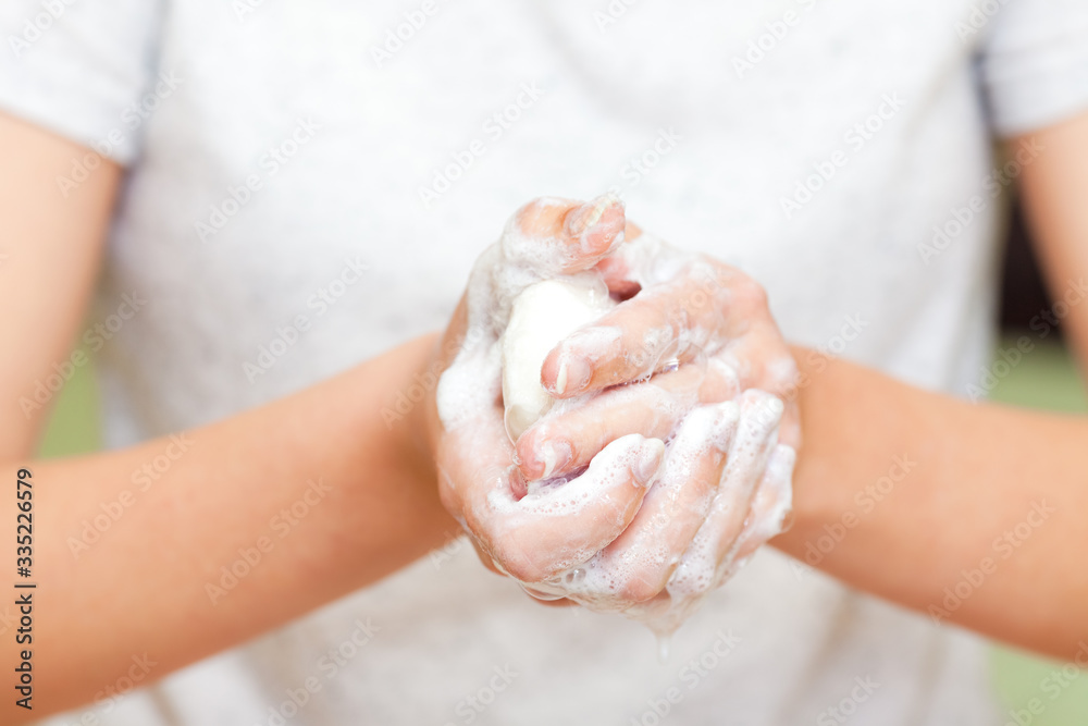 Front view on girls hands with soap foam Front view on girls hands with soap foam