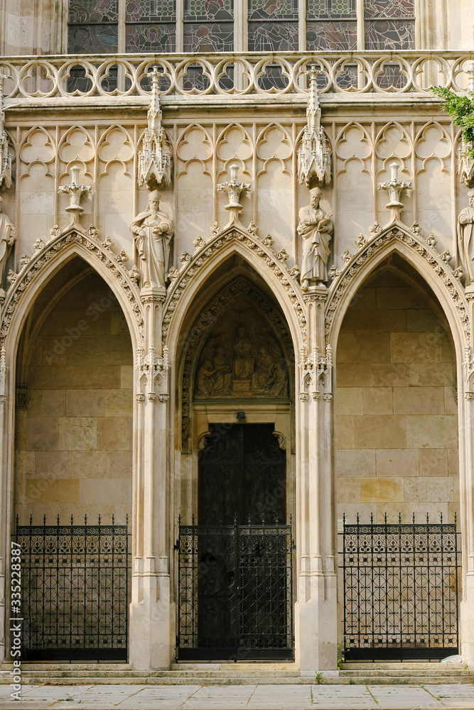Vienna, Austria - 06 June 2019: Door or gate of Neo-Gothic Votive Church (Votivkirche) on Ringstrasse - second-tallest church in Vienna. Vienna, Austria - 06 June 2019: Door or gate of Neo-Gothic Votive Church (Votivkirche) on Ringstrasse - second-tallest church in Vienna.