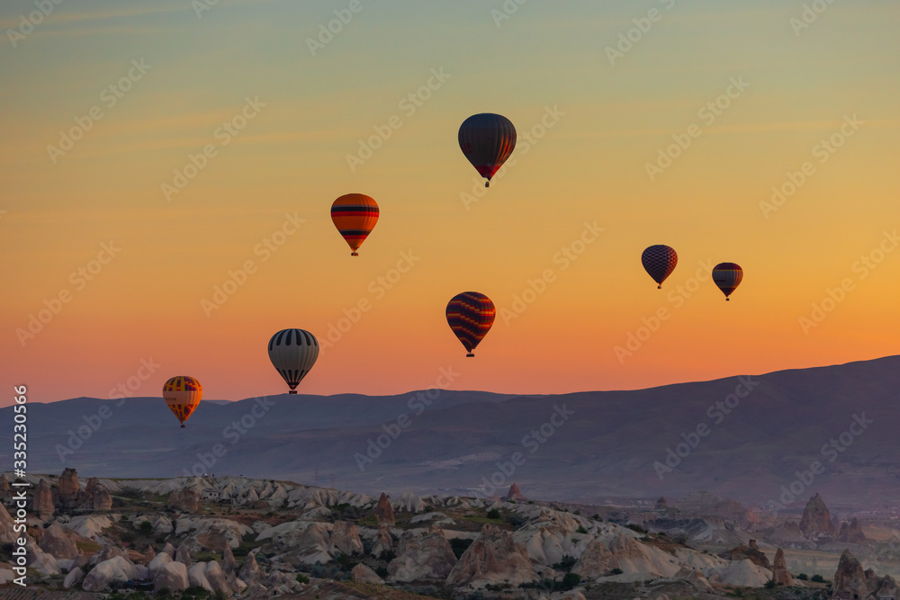 Hot Air balloons flying over amazing rock forms in Cappadocia