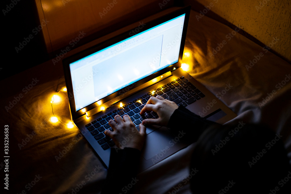 Top view of a woman working with the laptop at night. Top view of a woman working with the laptop at night.