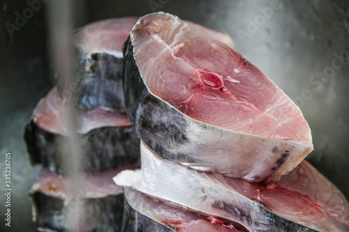 Cut spanish mackerel raw fresh pieces in the kitchen sink. photo