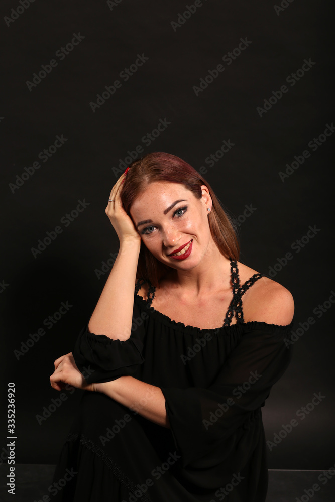 Studio portrait of pretty woman in black dress on dark background Studio portrait of pretty woman in black dress on dark background