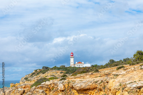 famous historic lighthouse of Carvoeiro at the wild coast of the Algarve at Carvoeiro