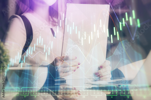 Wallpaper Mural Double exposure of hands making notes with forex chart huds. Stock market concept. Torontodigital.ca