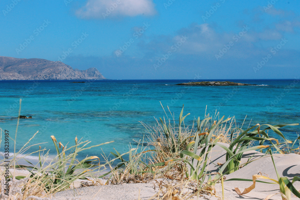 Tropical beach with white sand dune in front and azure water sea. Beach and sea photo