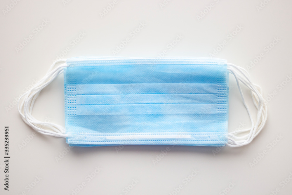 Blue medical masks, as protection against viruses, on white background, selective focus, concept, covid19 Blue medical masks, as protection against viruses, on white background, selective focus, concept, covid19
