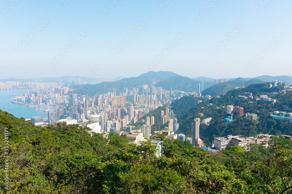 Fototapeta premium Hong Kong's beautiful skyline. The Peak Tower deck view (The Peak) on a sunny day, Hong Kong, China. Hong Kong Island and Kowloon's skyscrapers & South China Sea. Near Victoria Peak.