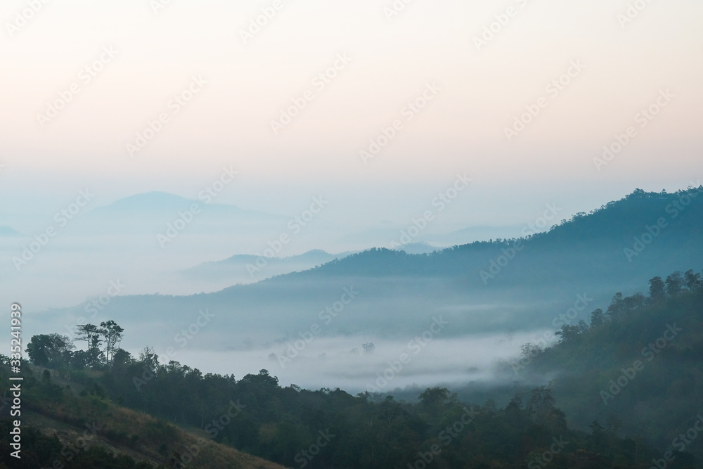 A beautiful landscape of mountains in the morning and winter fog. Chiang Rai, Thailand.