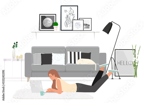 Girl lying on the floor works at a laptop.
