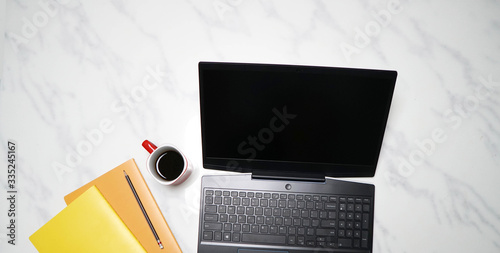 Workspace with modern laptop on white maeble background, Top view photo