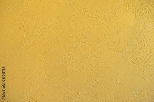 Yellow wall background with embossed abstract pattern