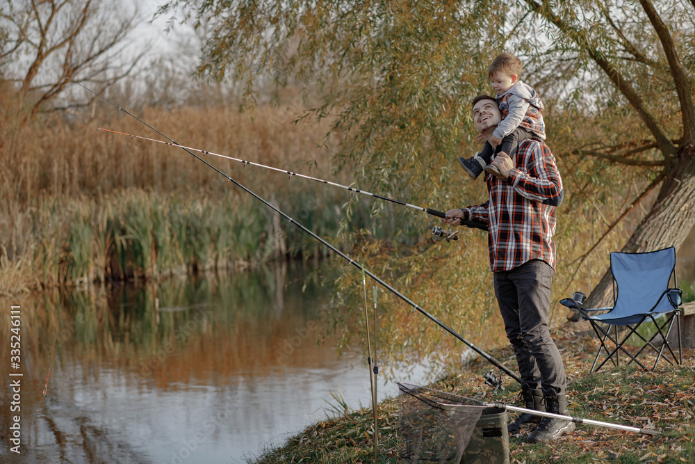 Family by the river. Guy in a red shirt. Father with in a fishing. Family by the river. Guy in a red shirt. Father with in a fishing.