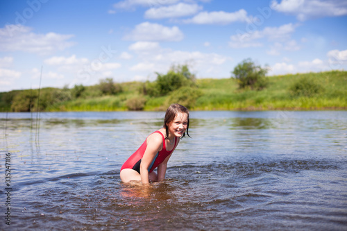 Girl swimming in warm river.