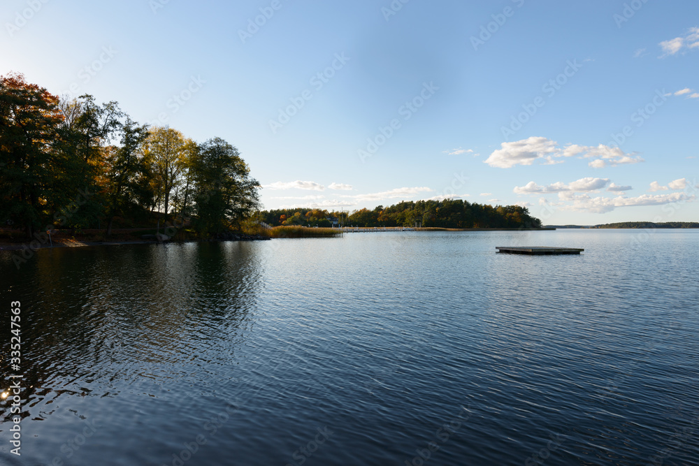 View of river and sky with autumn forest along the riverside