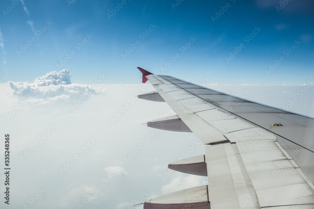 View of beautiful cloud and wing of airplane from window View of beautiful cloud and wing of airplane from window