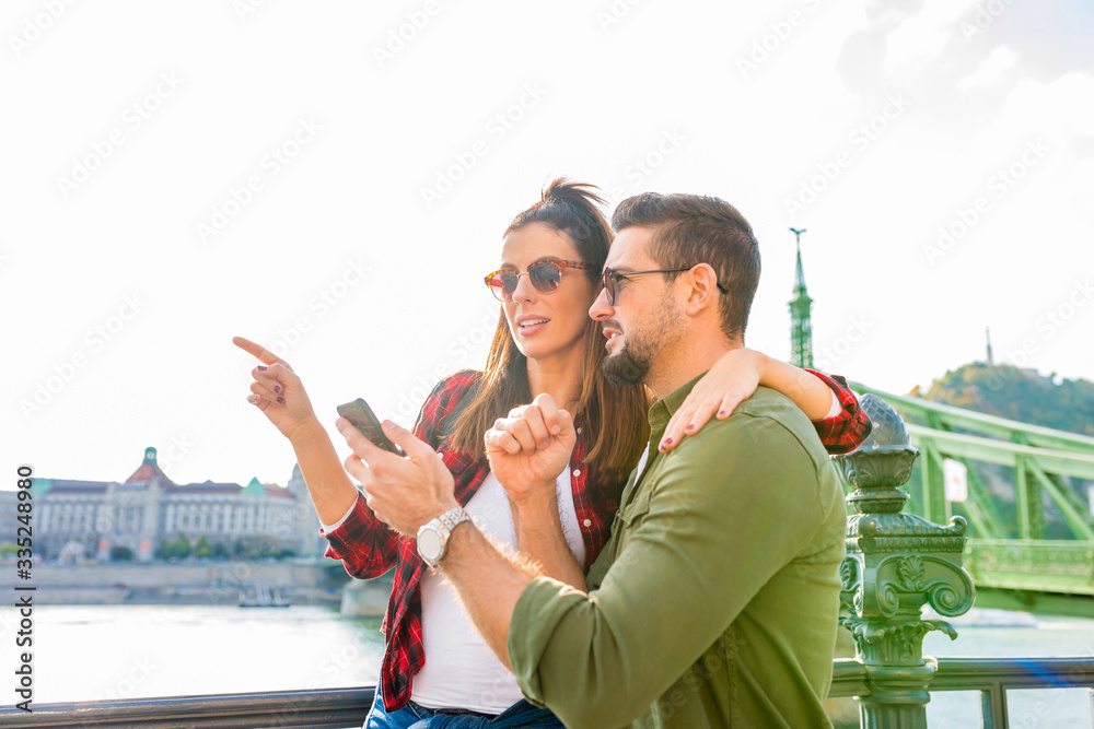 A happy couple discovering together a city A happy couple discovering together a city