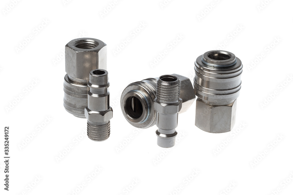 Set of male and female steel quick couplings with thread, isolated on white background Set of male and female steel quick couplings with thread, isolated on white background