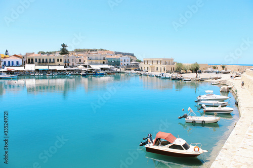 Motor boats at pier in small harbor of old European city. Summer travel concept