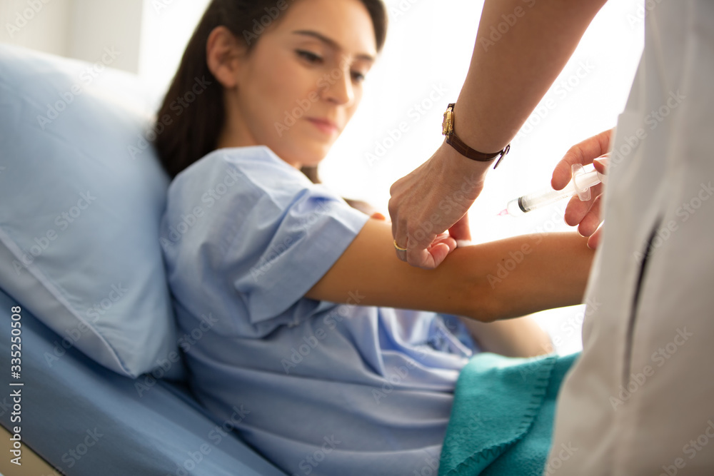 Doctor inject vaccine to antivirus into women patient in hospital Doctor inject vaccine to antivirus into women patient in hospital