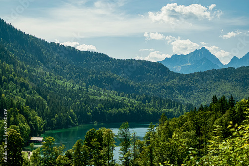 Panoramic view of the Alps and the beautiful Alpsee lake. Photograph taken in Schwangau, Bavaria, Germany.