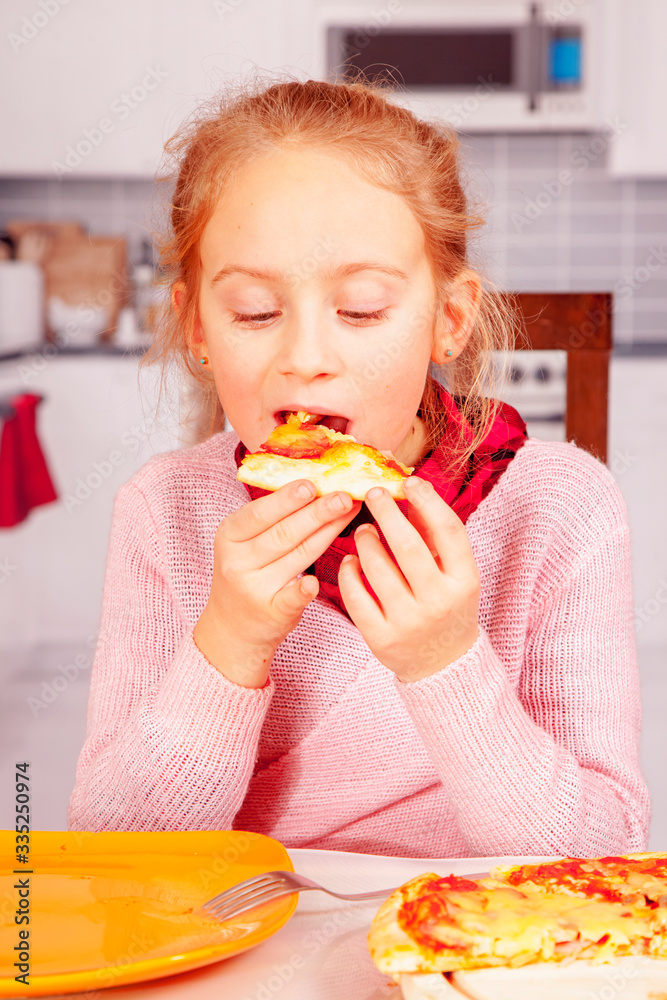 Portrait of cute little child girl with pizza. Happy child having fun eating dinner.