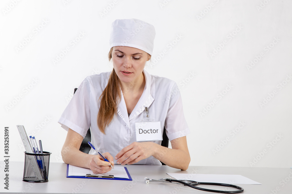 The doctor in a white coat makes notes. The doctor in a white coat makes notes.
