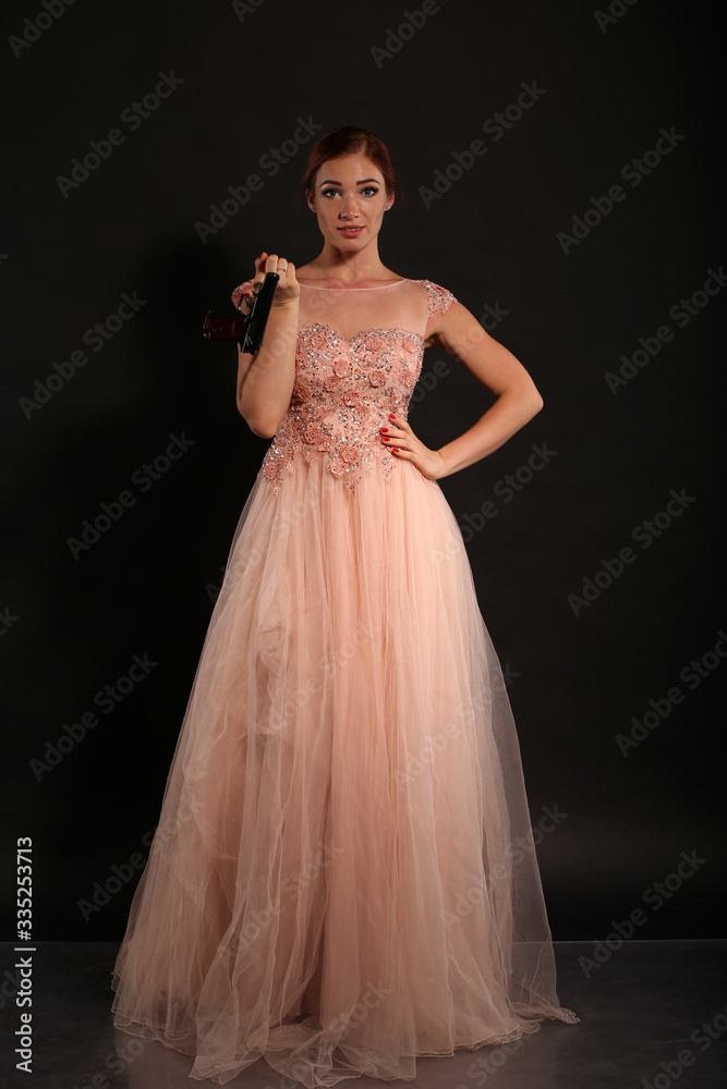 Fototapeta premium Cute girl in pink dress with Makarov pistol