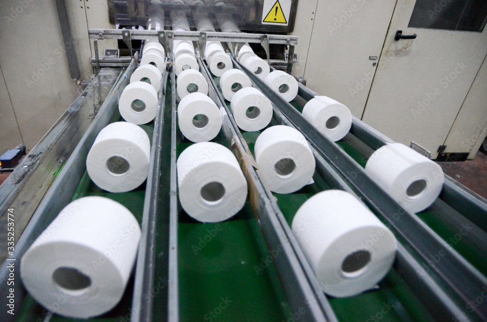 Production of Toilet paper in factory. Toilet paper rolls making