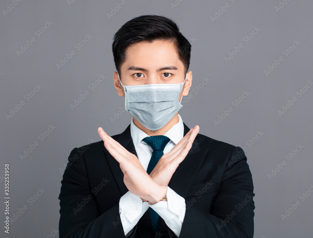 young man wear medical mask and showing no and stop sign gesture young man wear medical mask and showing no and stop sign gesture