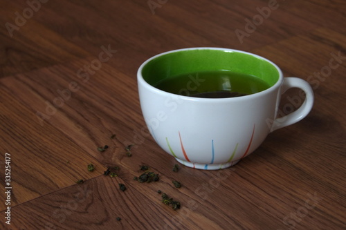 green tea in a mug on a dark background