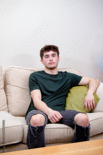 A young adult man on a sofa