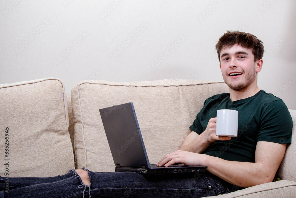 A young adult man on a sofa A young adult man on a sofa