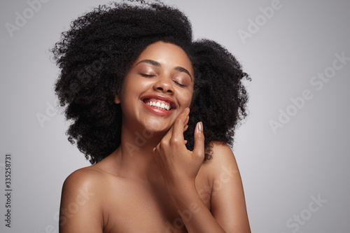 Happy black lady touching soft skin