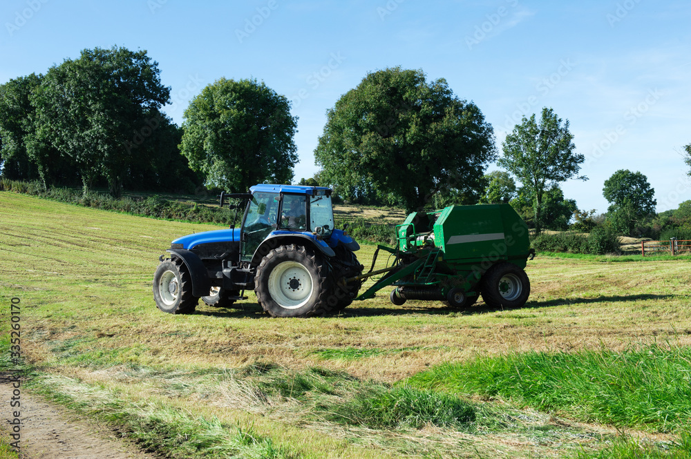 Fototapeta Tractor on the field
