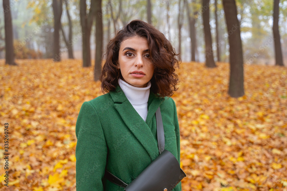 Serious young lady at daytime in the park stock photo Serious young lady at daytime in the park stock photo