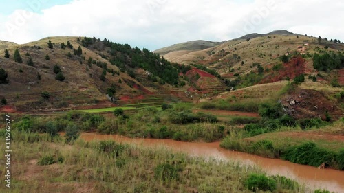 Drone footage over a paddy field with muddy river near Ambositra Madagascar photo