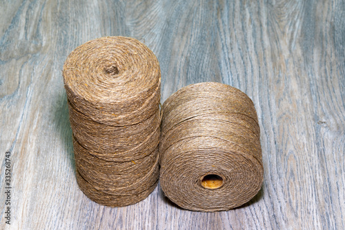 Skeins of jute twine over wooden background. Jute thread texture. Hanks of twine closeup. 