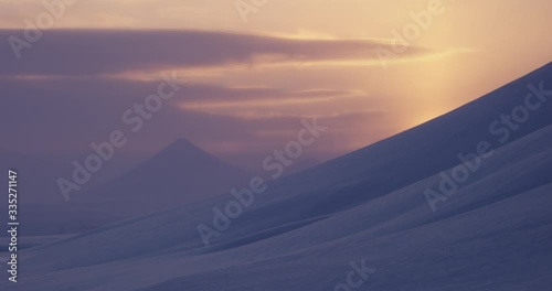 Sunset Shot infront of Snowmountains in Svalbard. photo