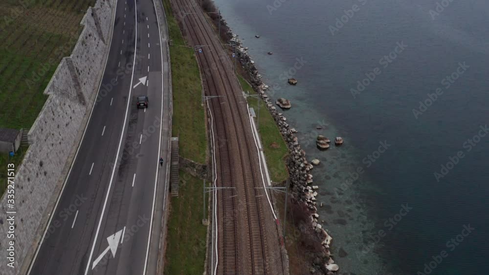 Aerial of highway and railway tracks near beautiful lake Aerial of highway and railway tracks near beautiful lake