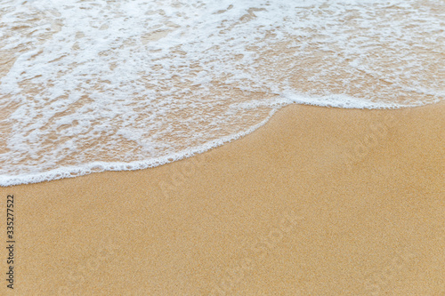 Clean fine sand beach and white wave background, nature concept, outdoor daylight, summer concept background
