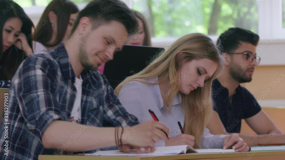 Students writing in university. Students writing in university.