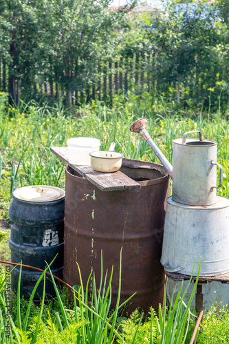 Tanks for watering in the garden: barrels and watering can