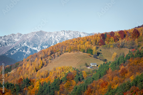 House on a hill in front of snowy mountain in Bran, Romania