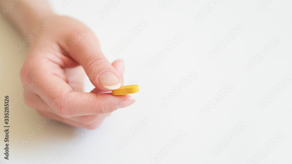Yellow tablet on the palm of a woman. Copy space Yellow tablet on the palm of a woman. Copy space