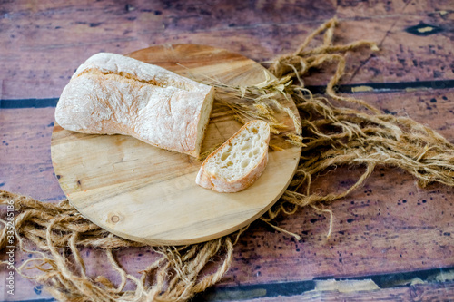 fresh baked bread on wooden background