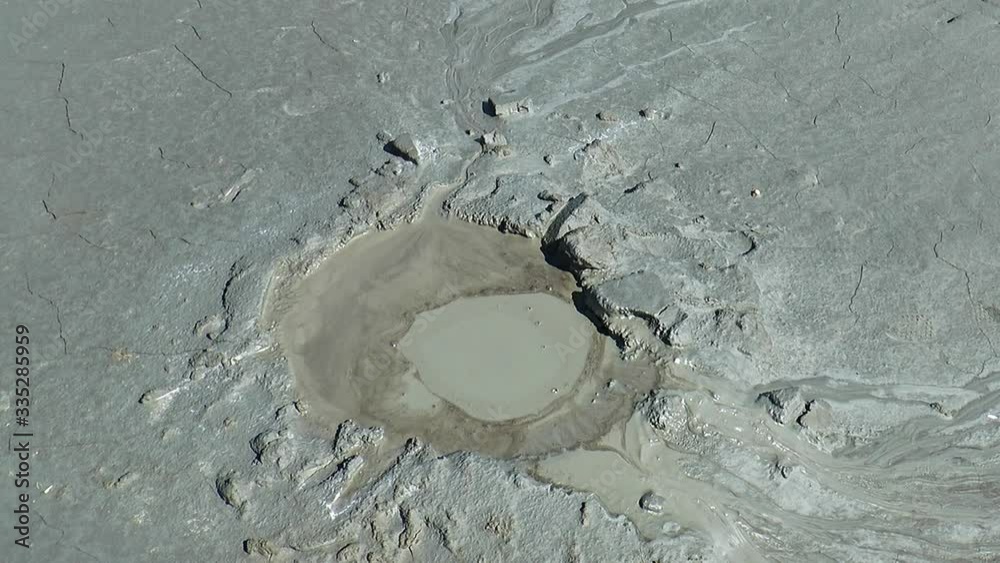 Mud volcano. A crater erupted mud out of liquid clay.