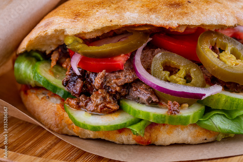 Beef pieces fried on trochanter with parsley and dill with pickles in a tortilla cooked in tandem photo