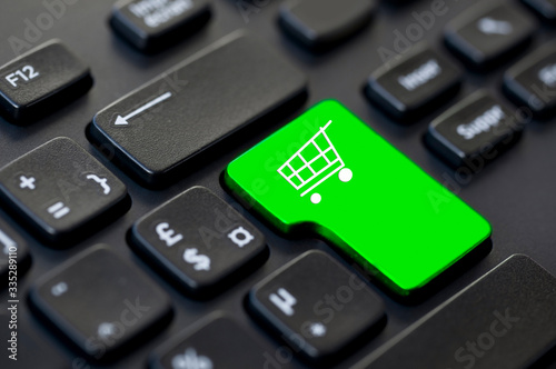 Shopping cart icon on a computer keyboard, online shopping and delivery concept